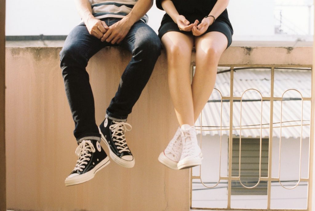 a person sitting on a ledge