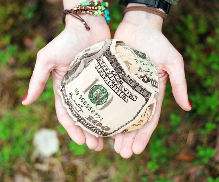 hands holding a small paper bag