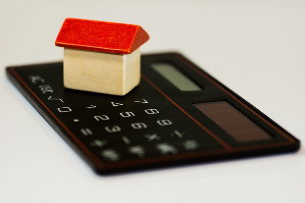 a black calculator with a red block on top