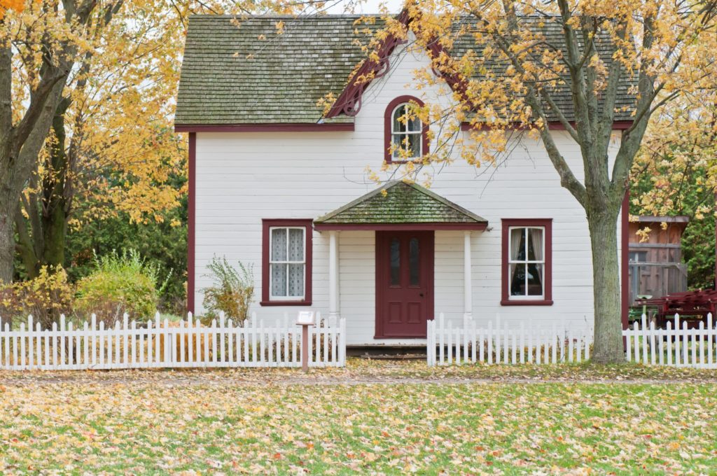 a house with a fence and trees