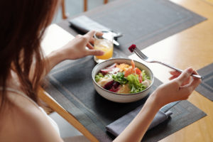 a woman eating a bowl of salad