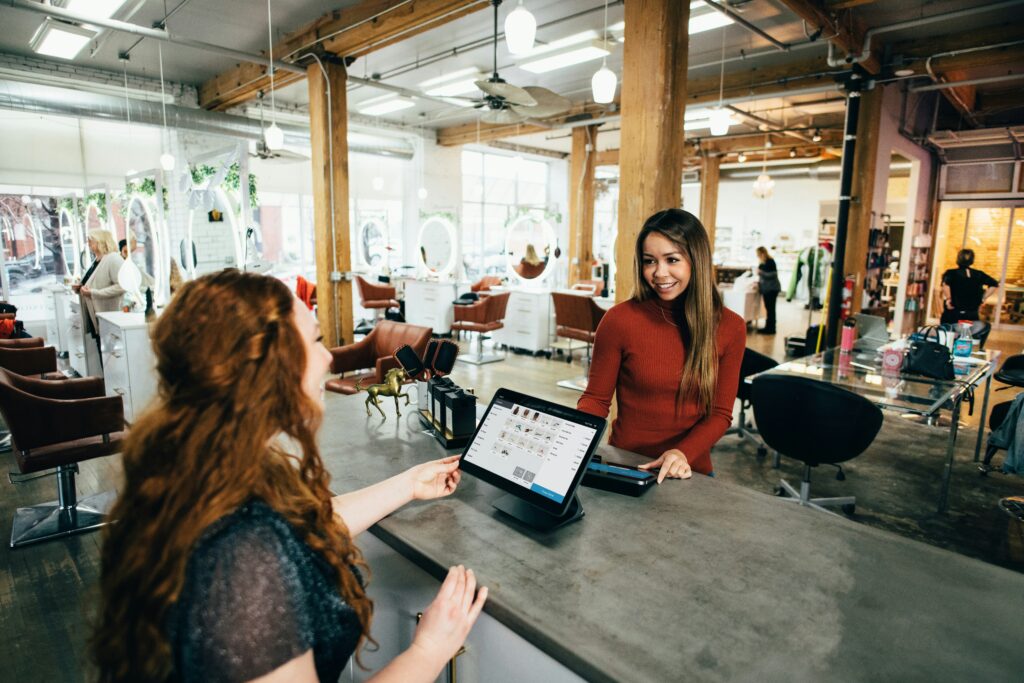 a person showing a person something on the tablet